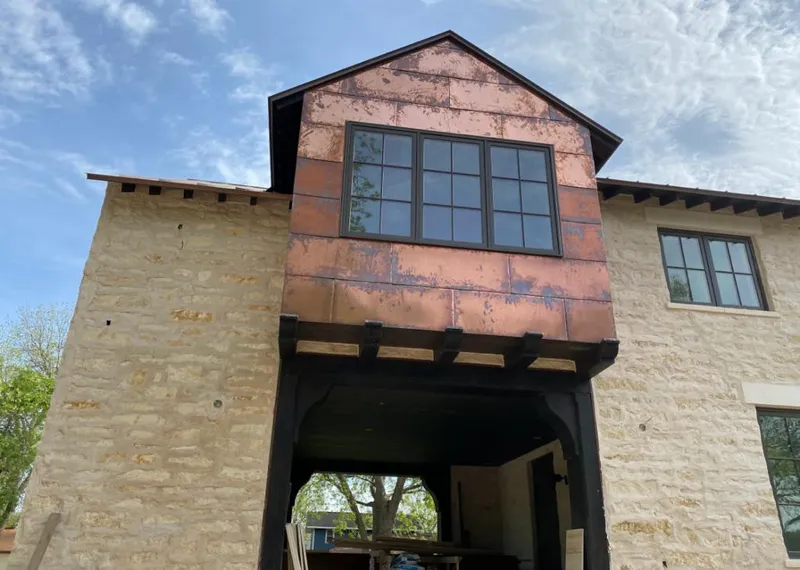 Copper metal panel facade on a stone building for Roof Repair in Jeffersontown