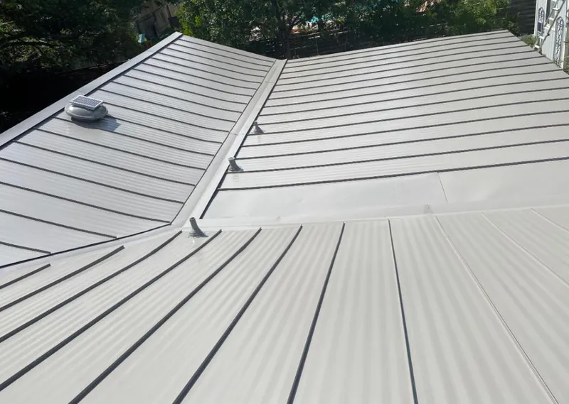 Solar attic fan installed on a metal roof for Roof Ventilation in Jeffersontown